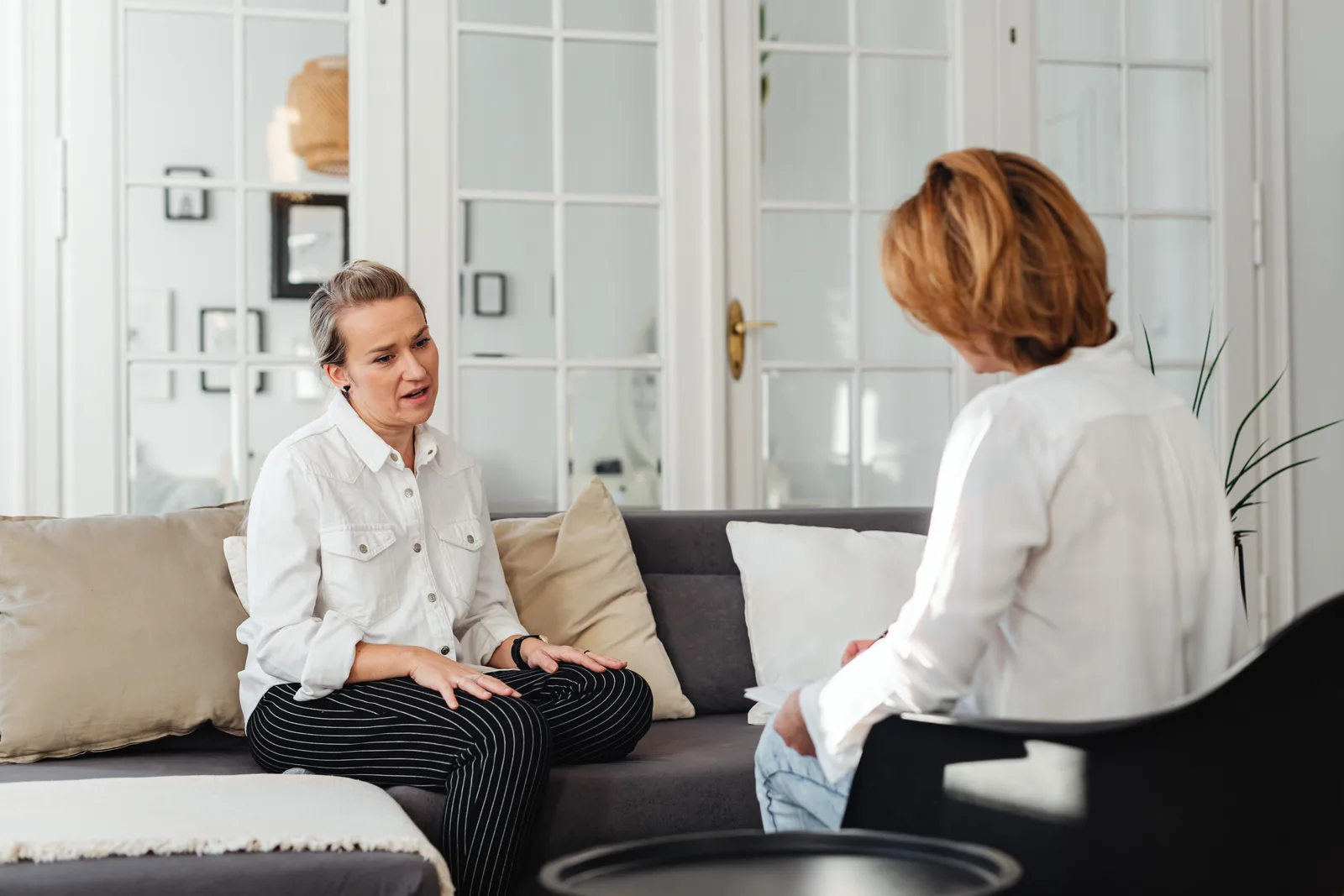 Two women seated and talking during a one-to-one conversation